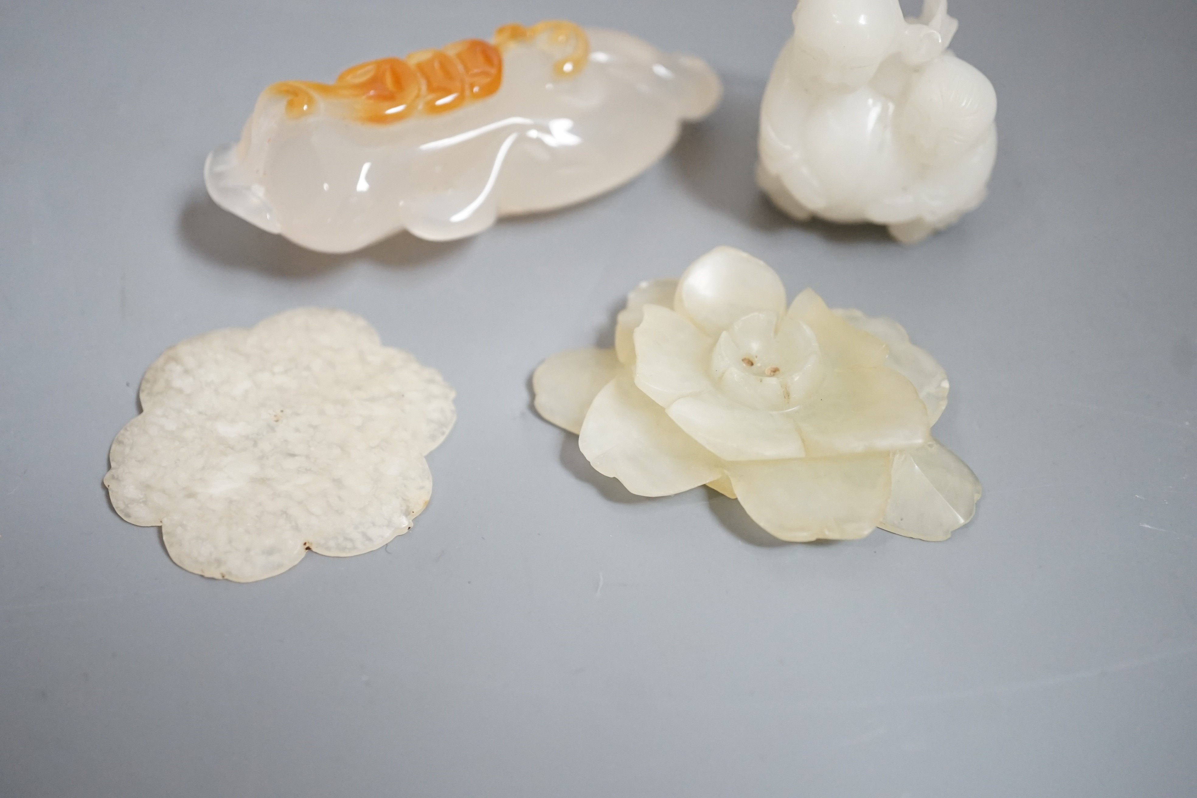 Two Chinese jade flower head carvings, Ming dynasty, a white Jade group of two boys and a monkey and an agate carving (4)